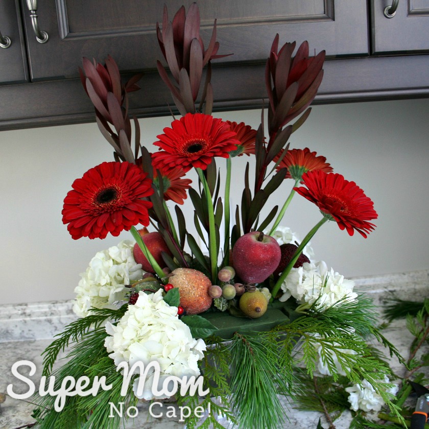 6 Red gerbera daisies added to the DIY Christmas floral arrangement