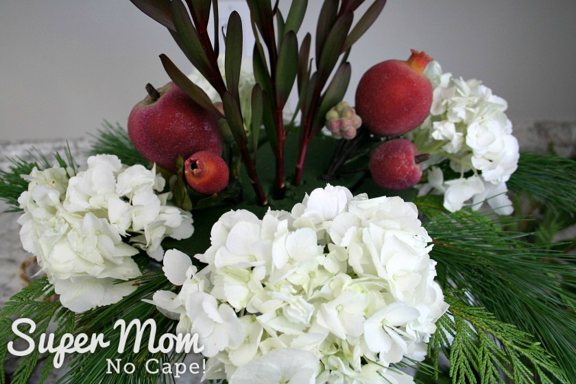 Hydrangeas and faux sugared fruit added to the DIY Christmas floral arrangement