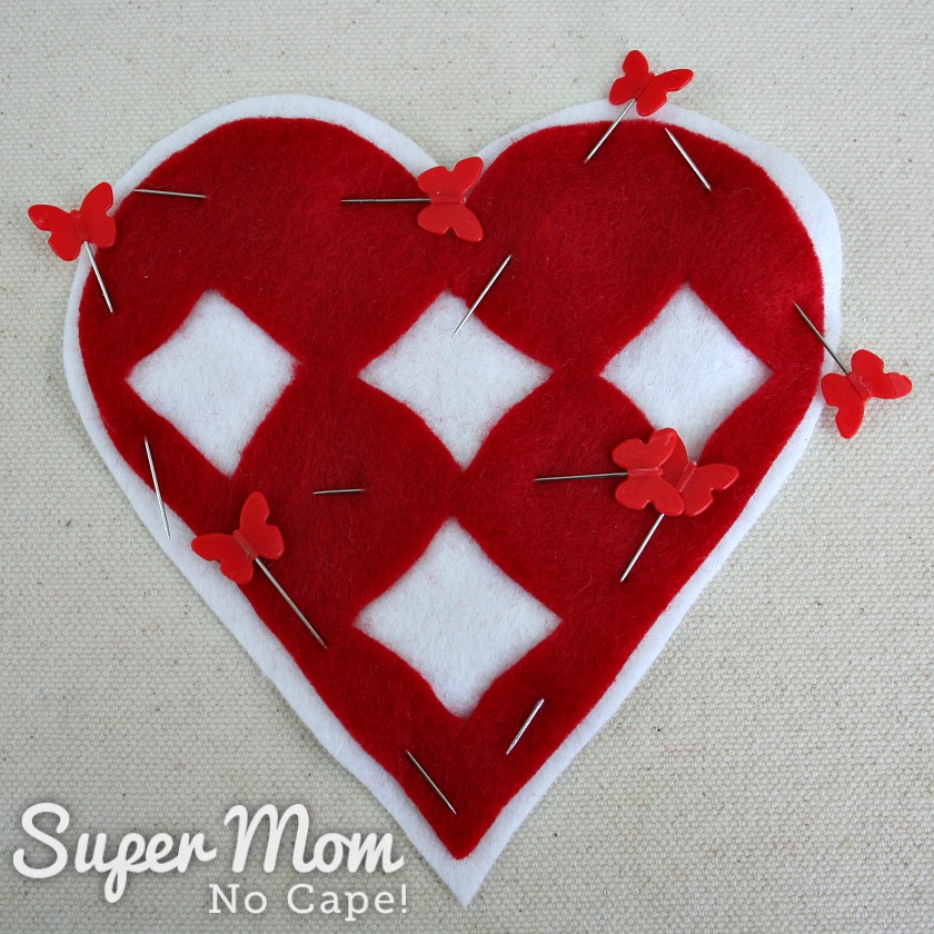 Cutwork red felt heart centered and pinned on white felt heart to make the I Heart Diamonds and Roses Sachet