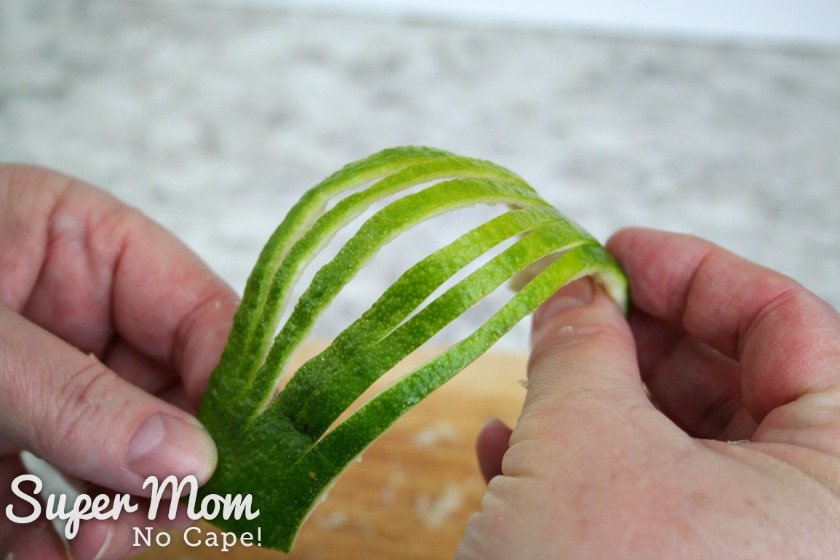 Fanning out the slits cut in the lime rind to make a lime rind fan garnish