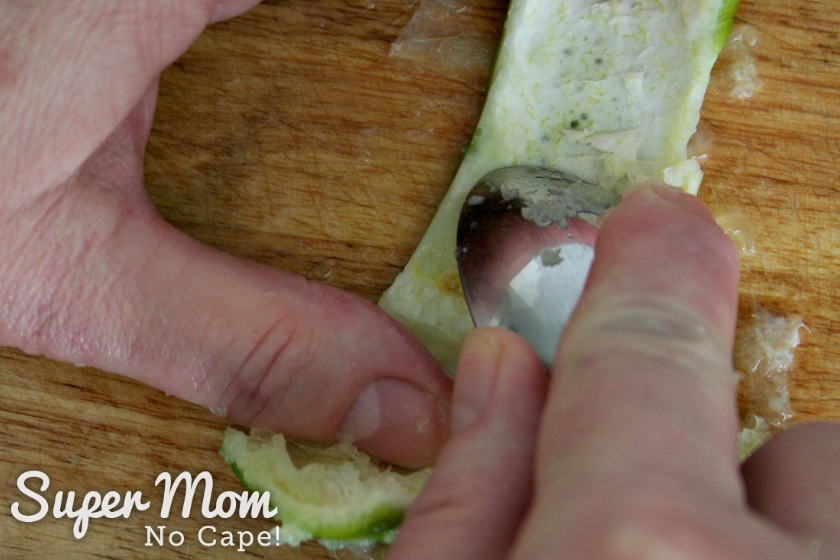 Scraping the pith off the lime rind to prepare it to make a lime rind fan garnish