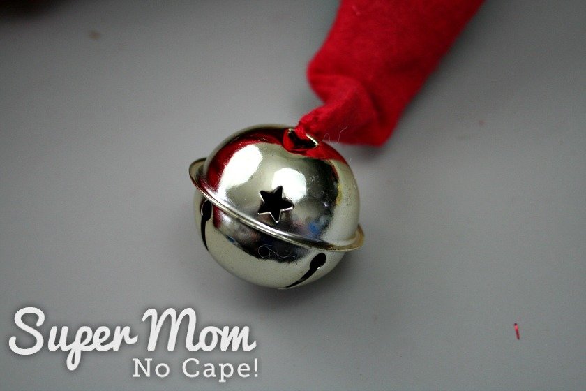 A silver bell sewn to the tip of the red gnome hat.