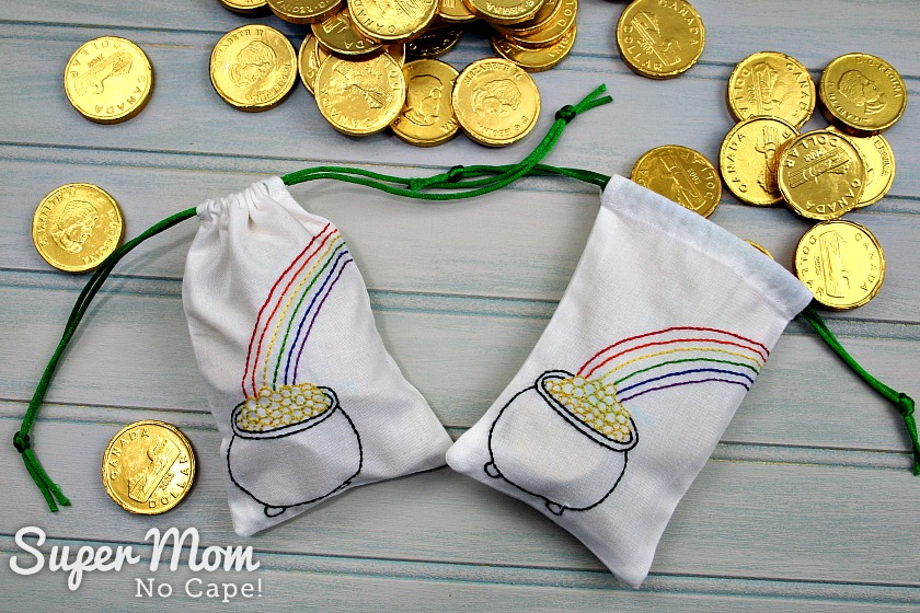 Drawstring bags with embroidery and pile of gold coins