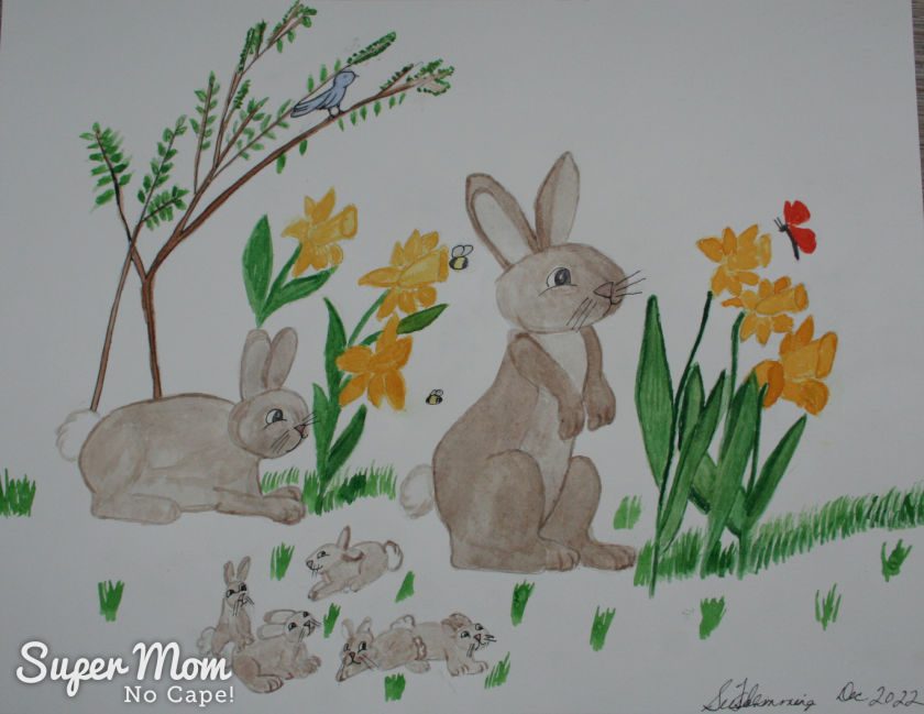 Photo of April's Calendar Page - Watercolor painting of of momma and poppa bunny with five little baby bunnies beside daffodils.