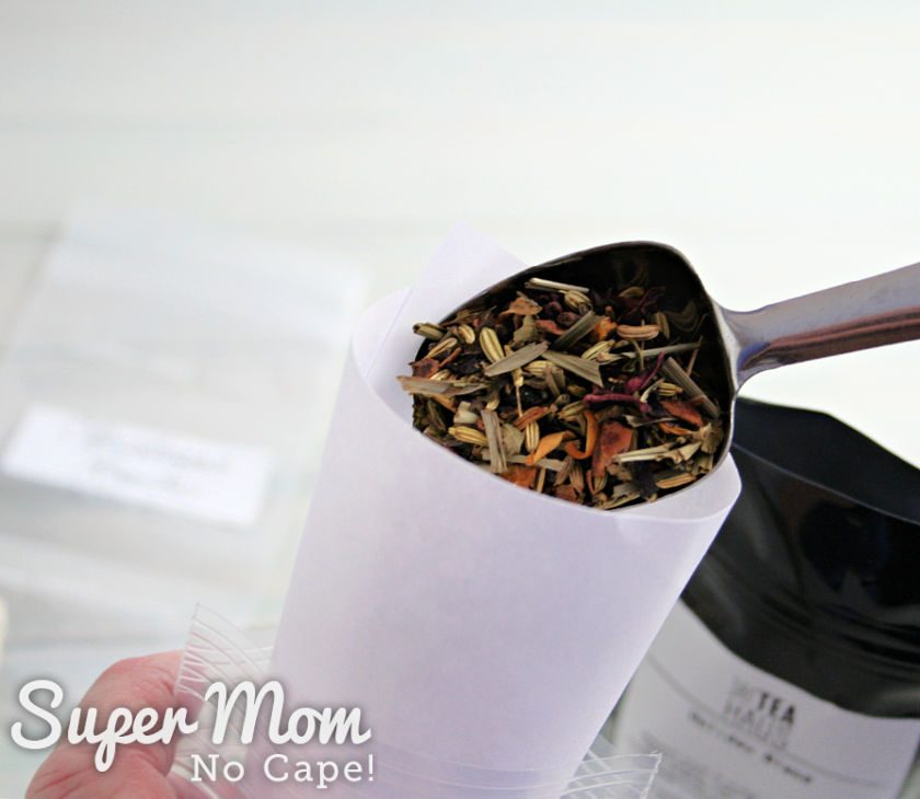 A picture of the loose leaf tea being poured into smaller bags to include in the tea mug/tea gift